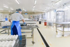 A clean food manufacturing facility with staff working
