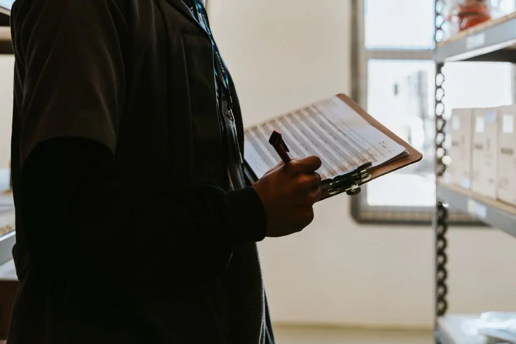 Worker checking inventory with a clipboard
