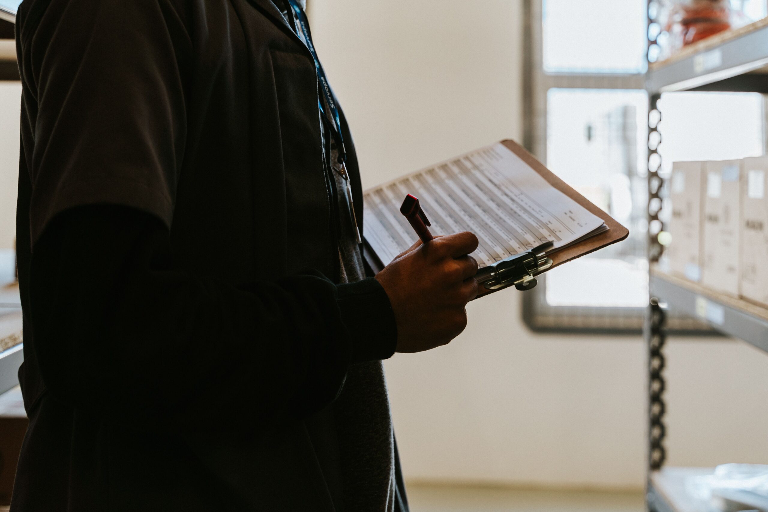 Worker checking inventory with a clipboard