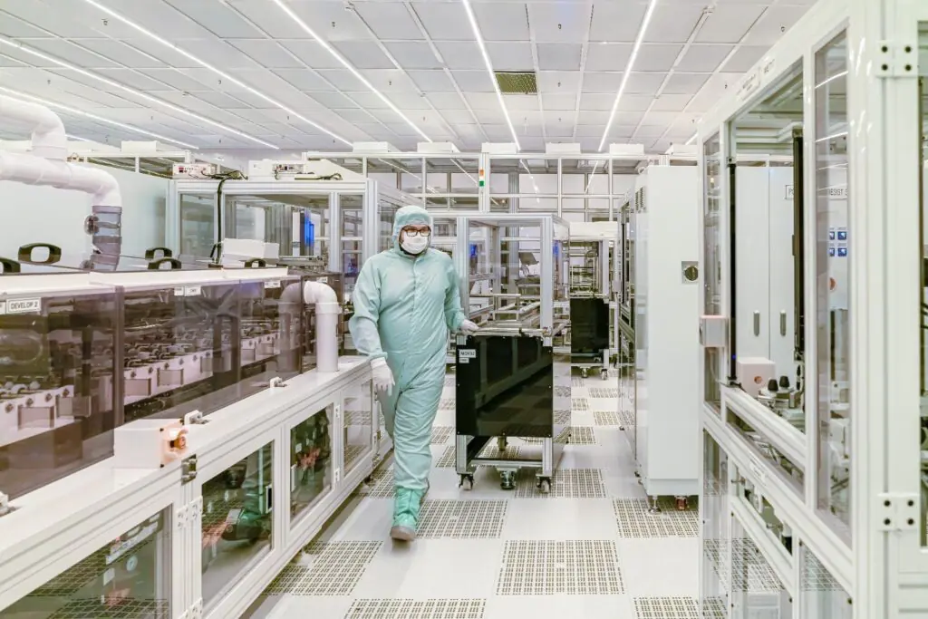 Worker in a protective suit inside a cleanroom facility