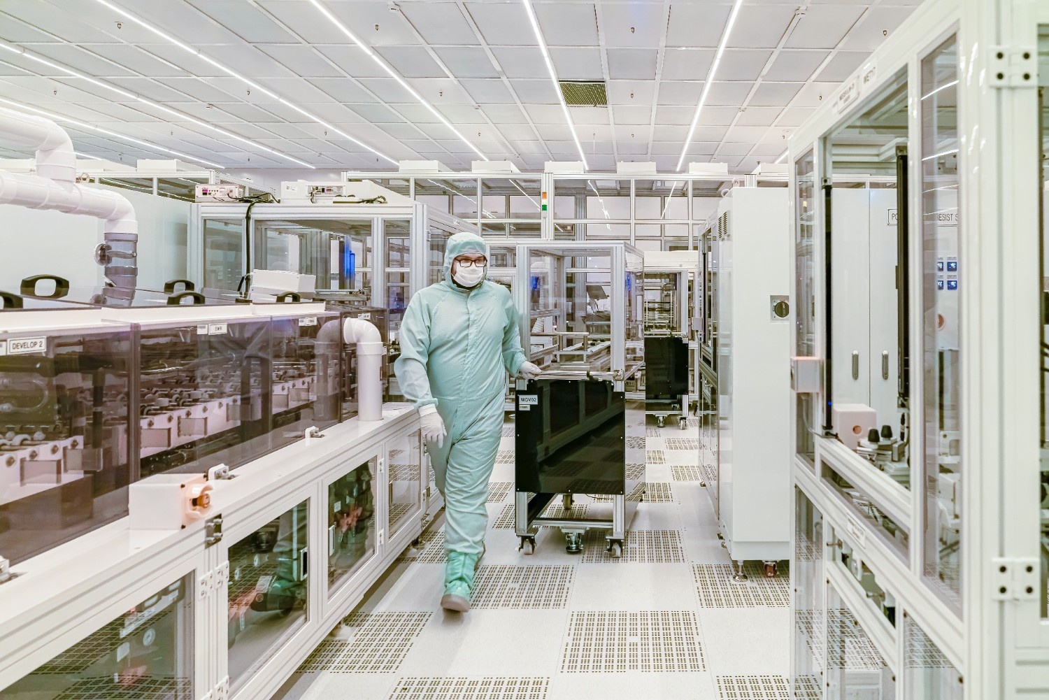 Worker in a protective suit inside a cleanroom facility