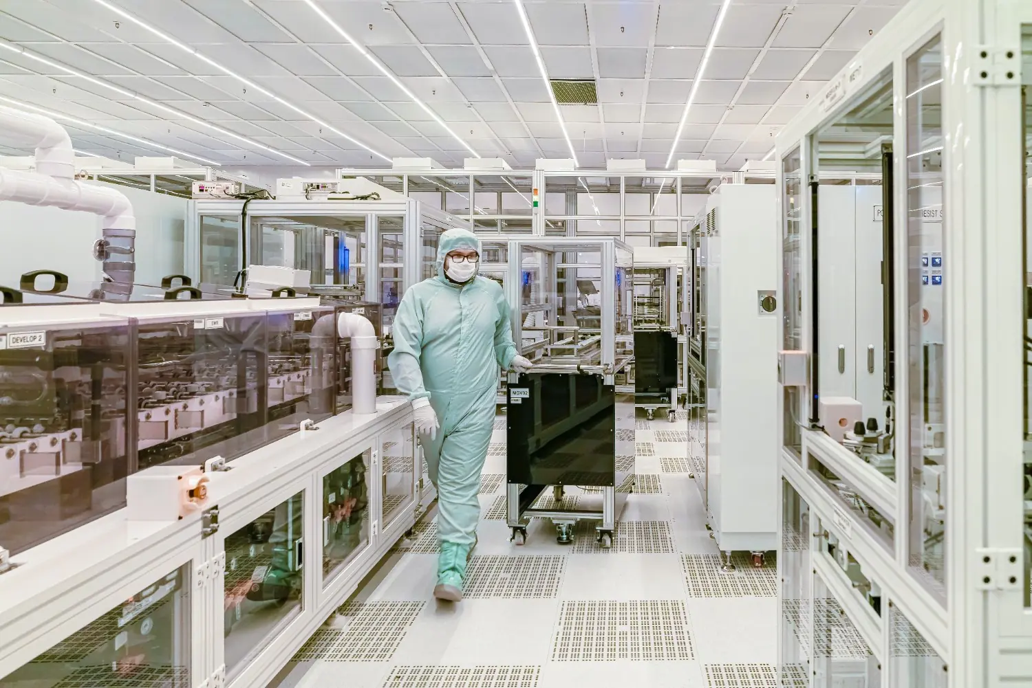 Worker in a protective suit inside a cleanroom facility