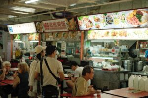 People dining at a hawker center with food stalls